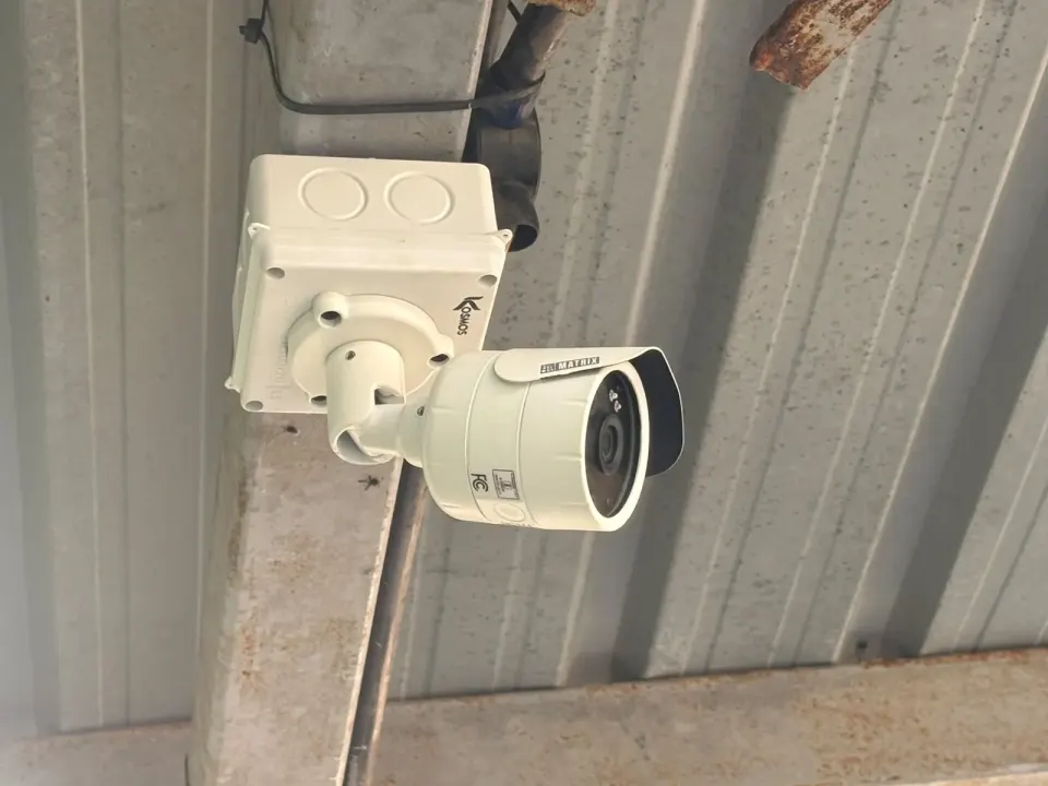 Matrix bullet camera with weatherproof junction box under a metal roof