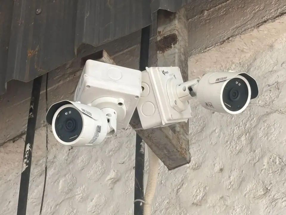 Two Matrix bullet CCTV cameras on a wall bracket overlooking the vehicle yard