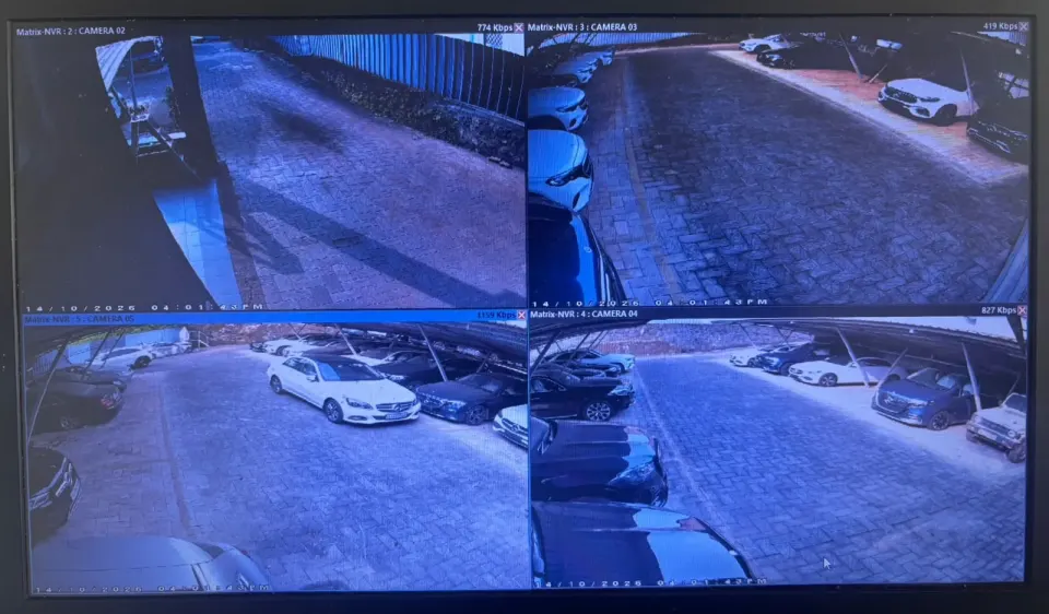 Matrix NVR live view showing four camera feeds of the dealership parking areas